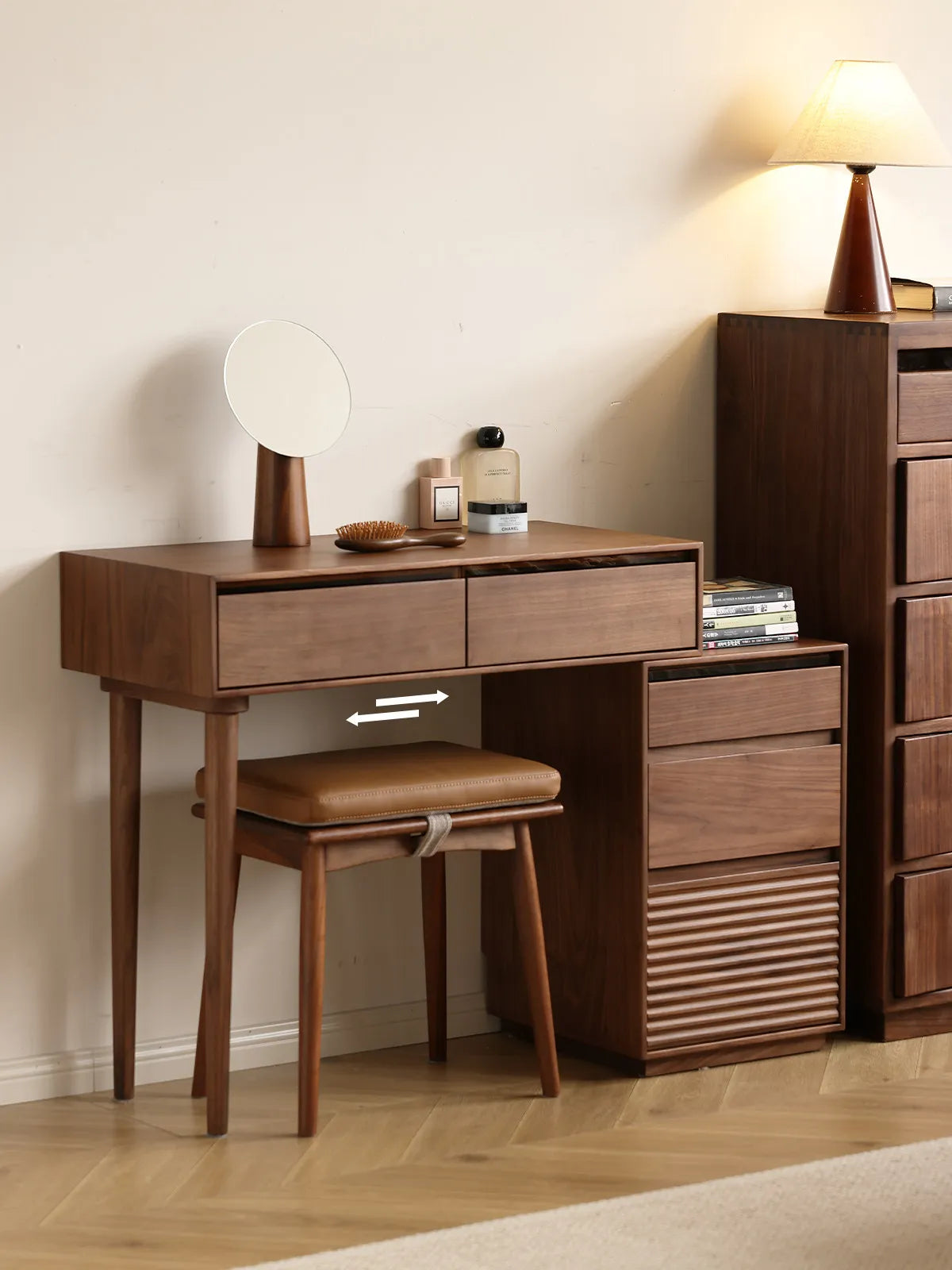 Demonstration of the adjustable, sliding design of the Walnutry Muse Vanity Desk extending over the integrated slatted nightstand to fit various spaces.