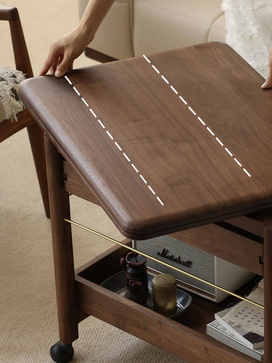 Close-up of the drop-leaf folding mechanism on The Nomad Mobile Side Table, highlighting the premium North American Black Walnut wood grain.