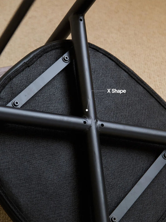 Underside of the Noren dining chair showing X-shape steel cross brace and seat construction