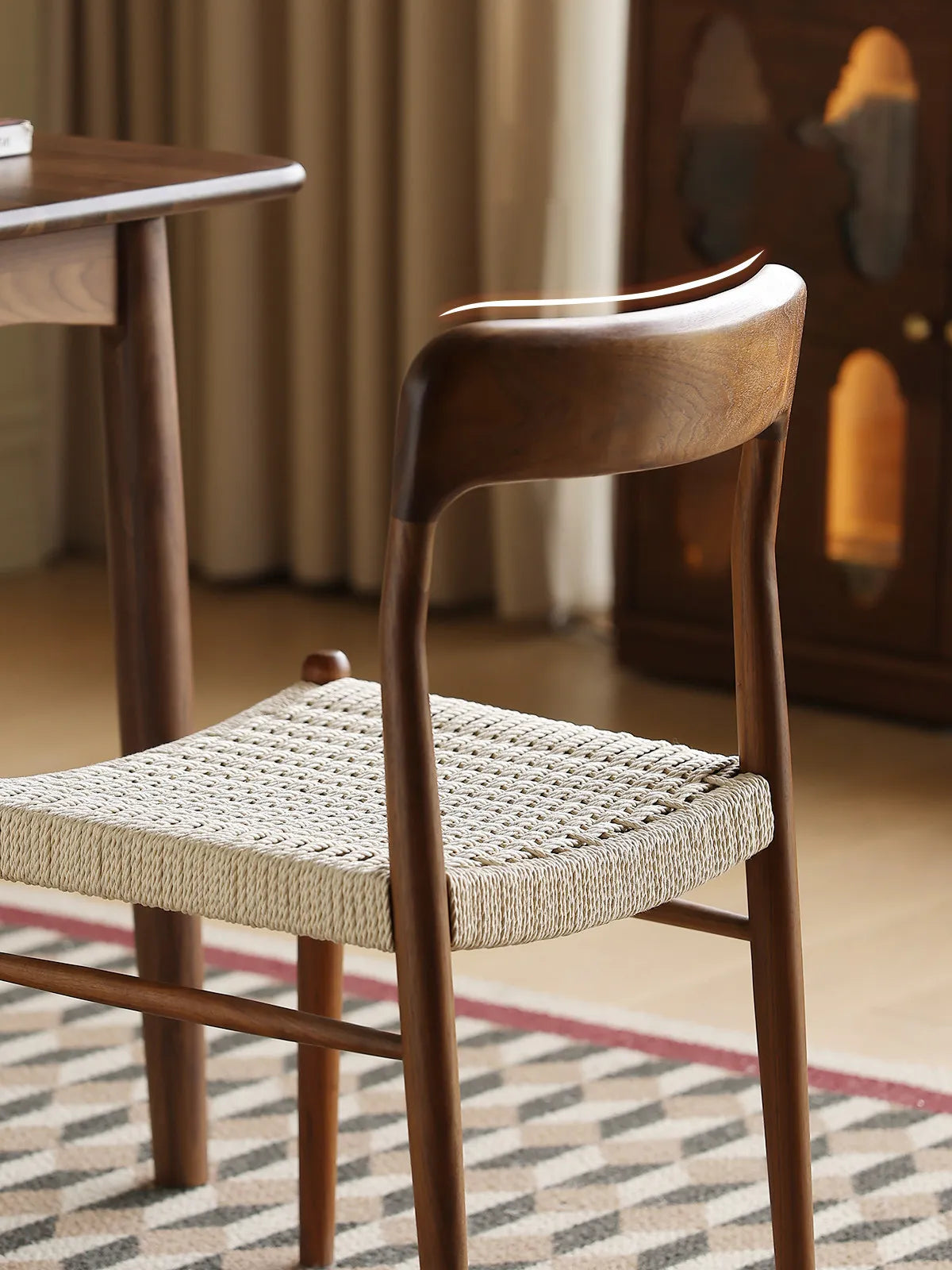 Detail of sculpted walnut backrest and rear leg joint on the Orin dining chair