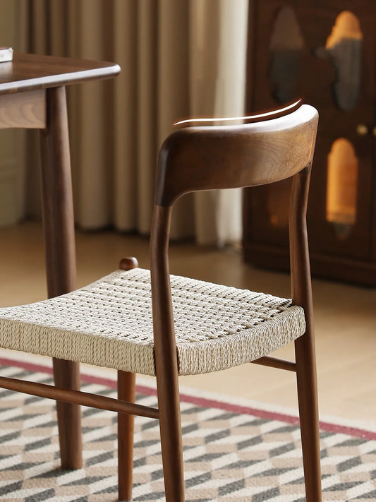 Detail of sculpted walnut backrest and rear leg joint on the Orin dining chair