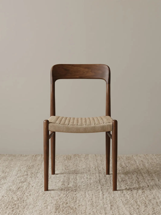 Orin woven cord dining chair in solid American black walnut, front view on neutral rug