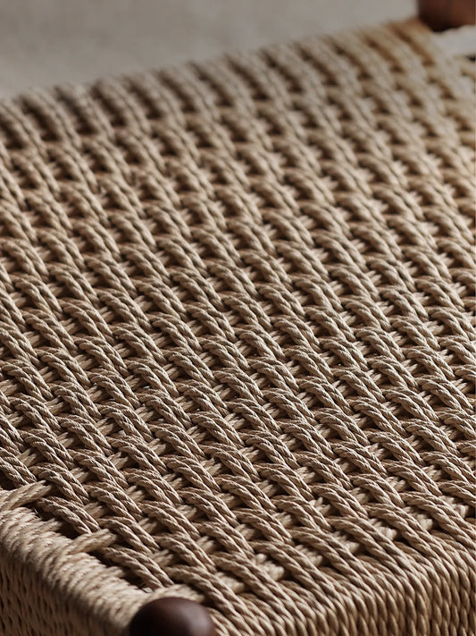 Close-up of hand-woven paper cord seat texture on the Orin dining chair