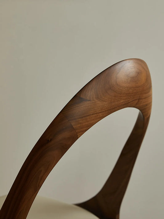 Detail shot of the Oryn chair's walnut grain texture and zero-VOC hard wax oil finish.