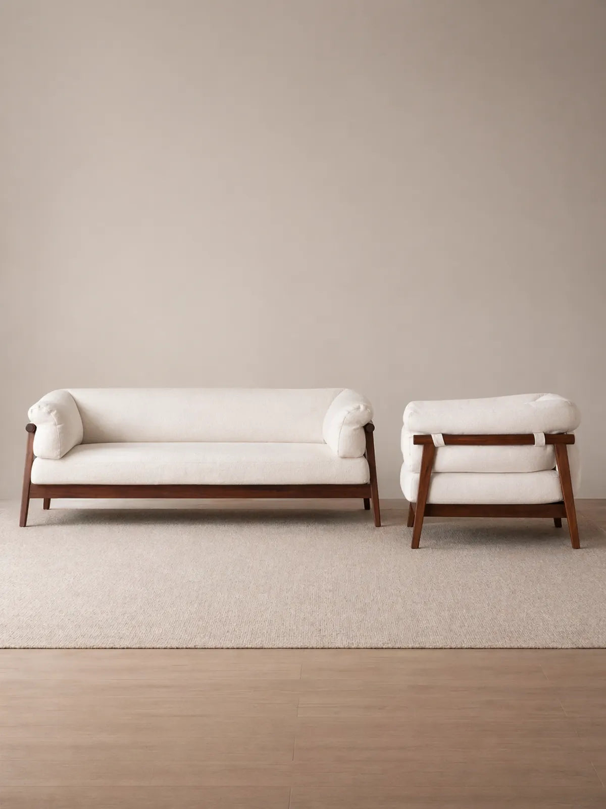 Oslo 3-seater sofa and single chair in cream bouclé with solid walnut frame, front view on neutral background (3-Seater with Chaise Lounge)