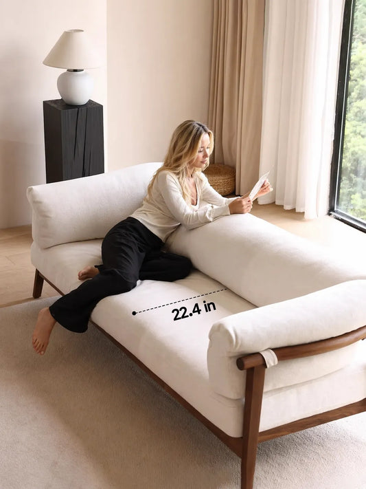 Oslo sofa seat depth measurement showing 22.4 inches with woman reading on the sofa