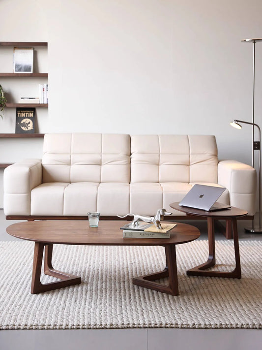 Front view of the two-piece Pebble Nesting Coffee Table Set displayed in a bright, minimalist living room.