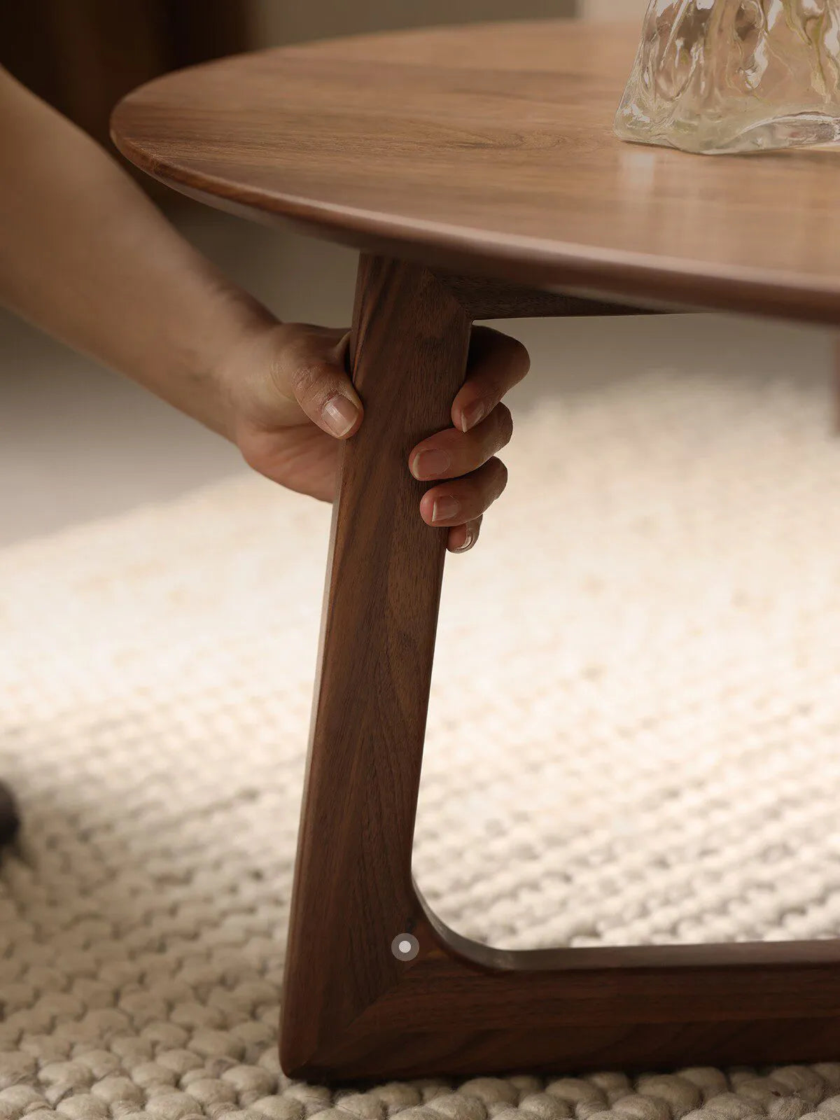 Close-up of the solid North American Black Walnut leg and smooth joinery of The Pebble Nesting Coffee Table by Walnutry.