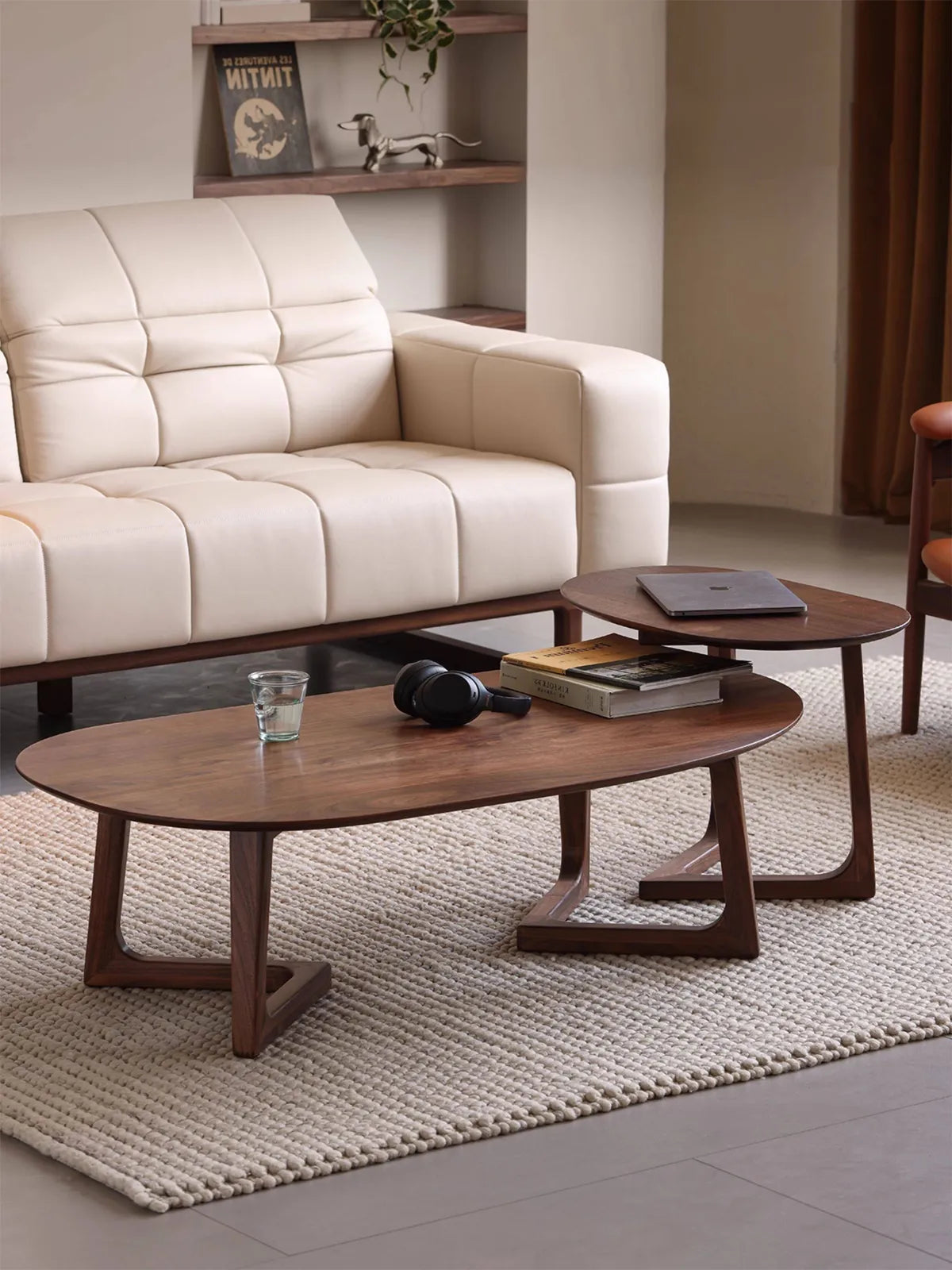 The Pebble Nesting Coffee Table Set by Walnutry, crafted from North American Black Walnut, styling a modern living room.