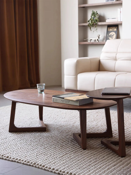 Angled view of The Pebble Nesting Coffee Table Set showing the functional and space-saving overlapping design.
