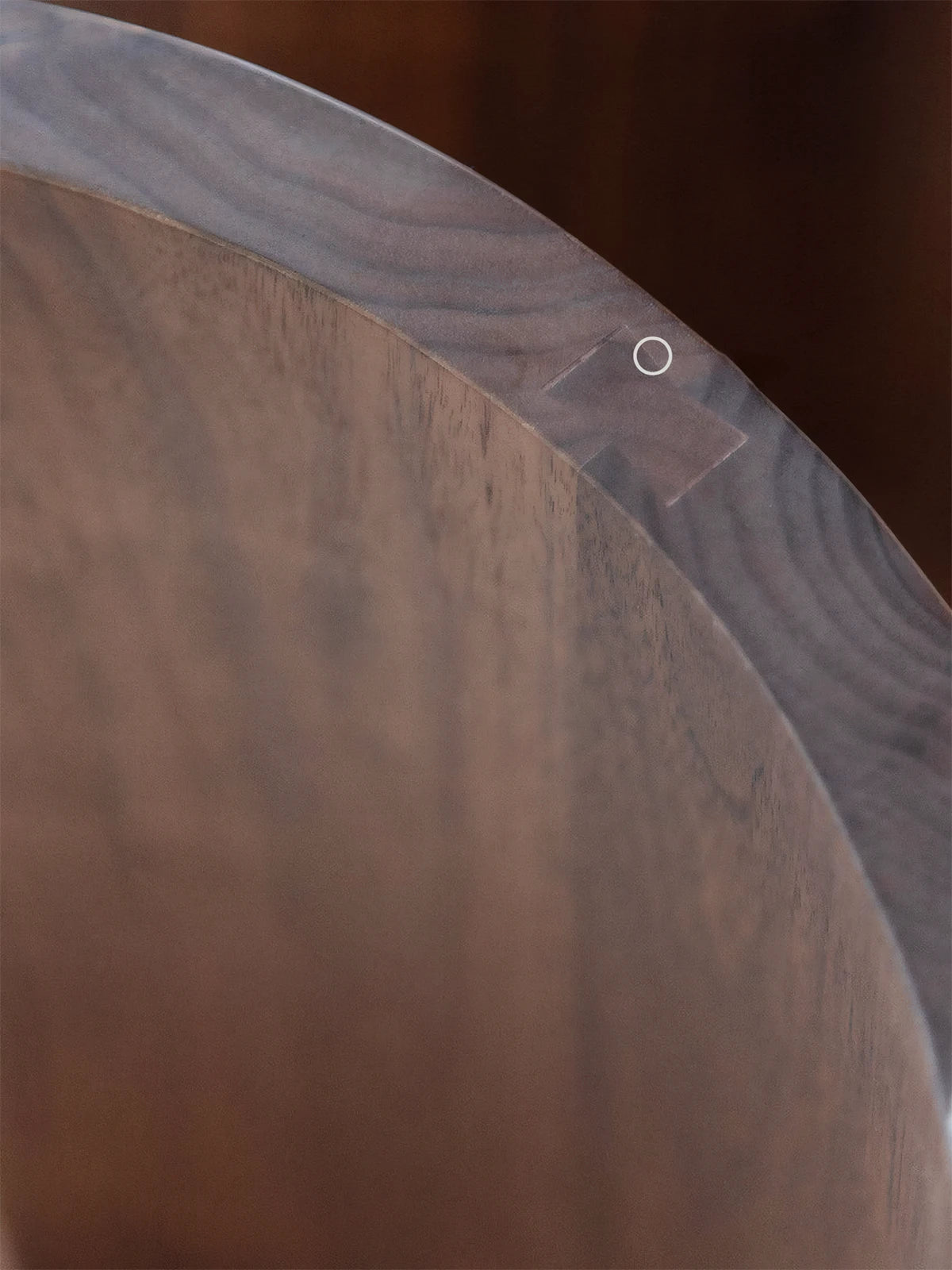 Macro detail shot of the rich North American Black Walnut grain and seamless joinery on this premium round walnut end table.