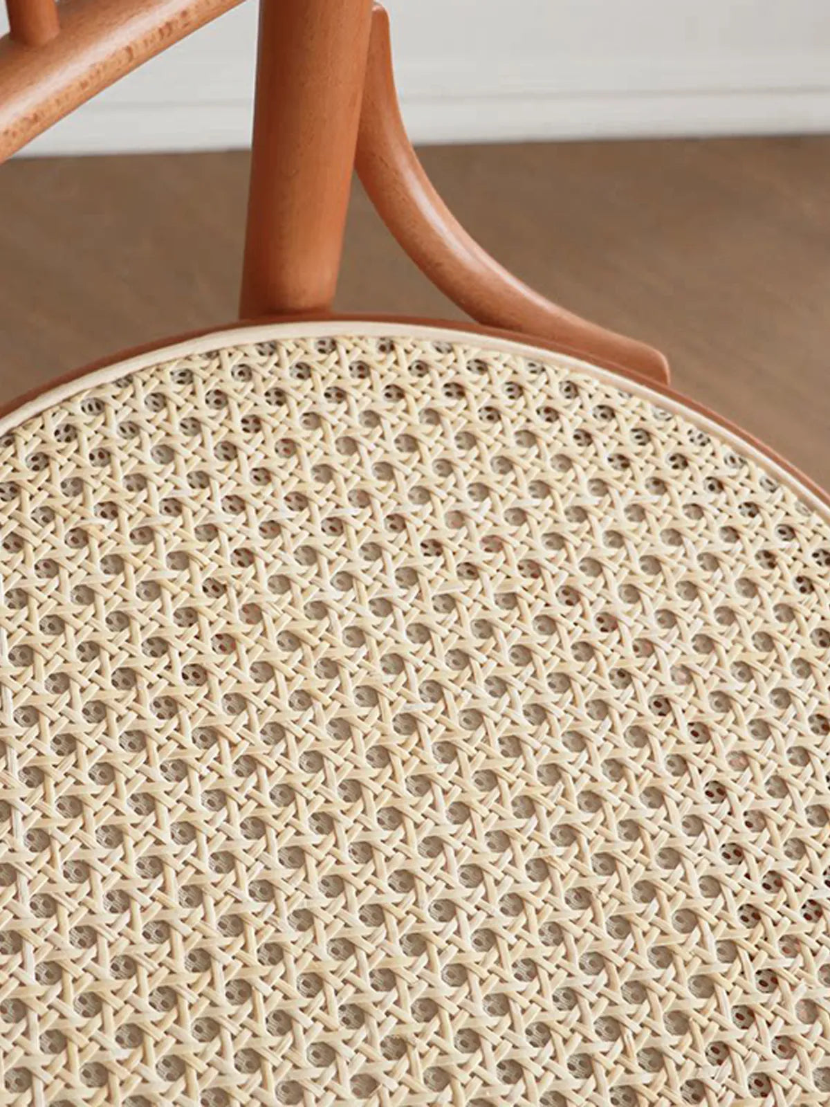 Close-up of natural rattan cane weave seat option on the Salo dining chair showing hexagonal cane pattern