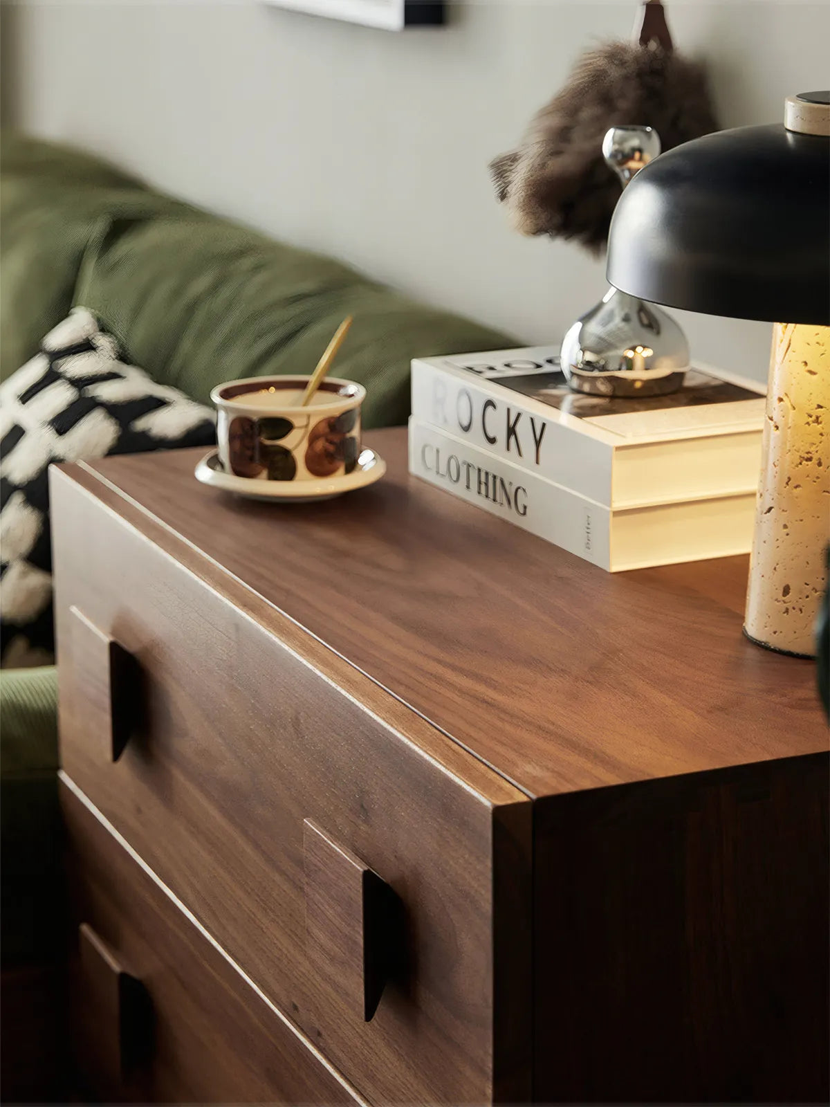 Close-up of solid North American black walnut modular nightstand with coffee cup and books, showing wood grain texture.