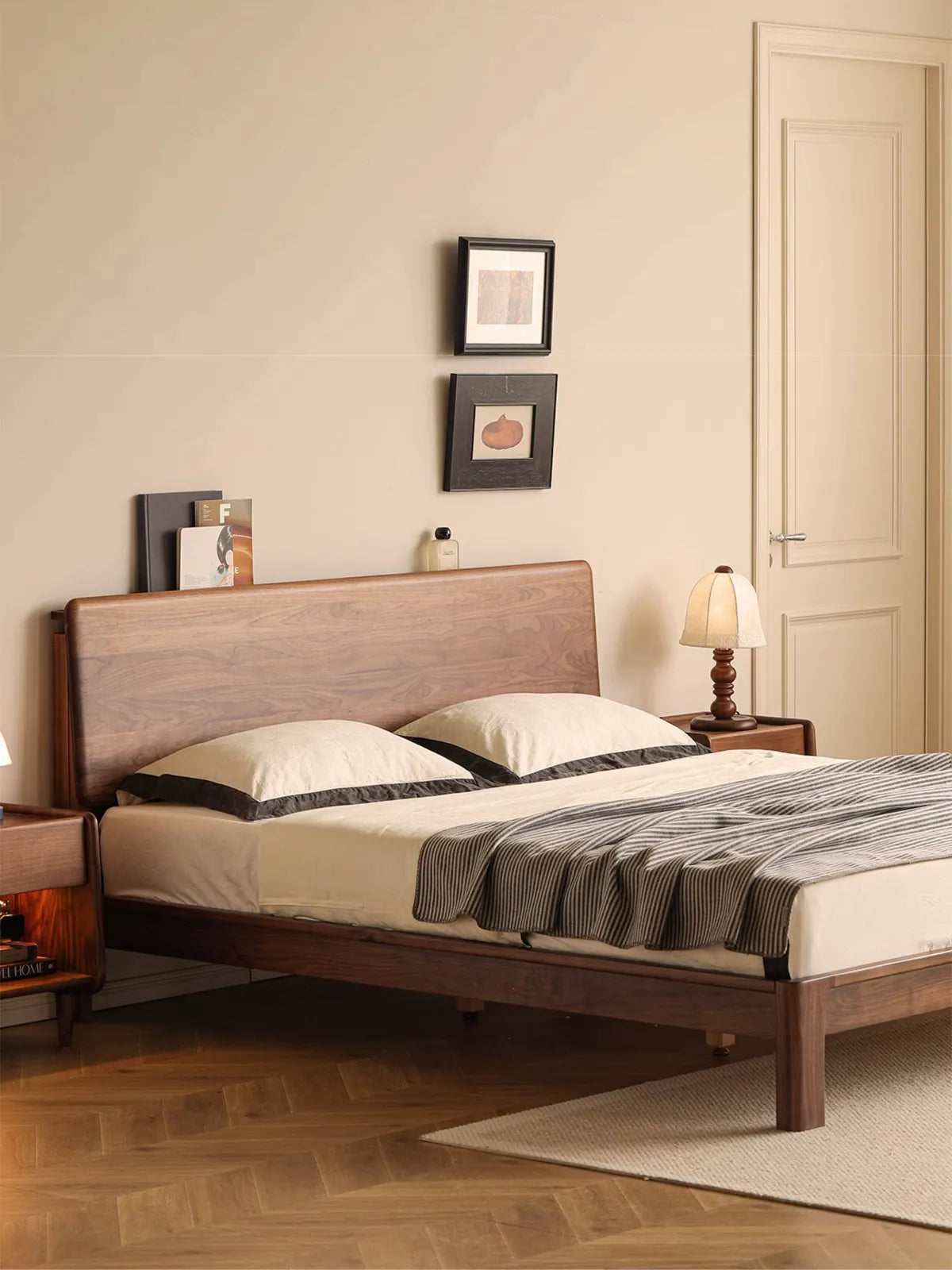 Angled view of a beautifully curated solid wood bedroom set, featuring The Haven platform bed frame and matching walnut nightstands in a cozy room setting.