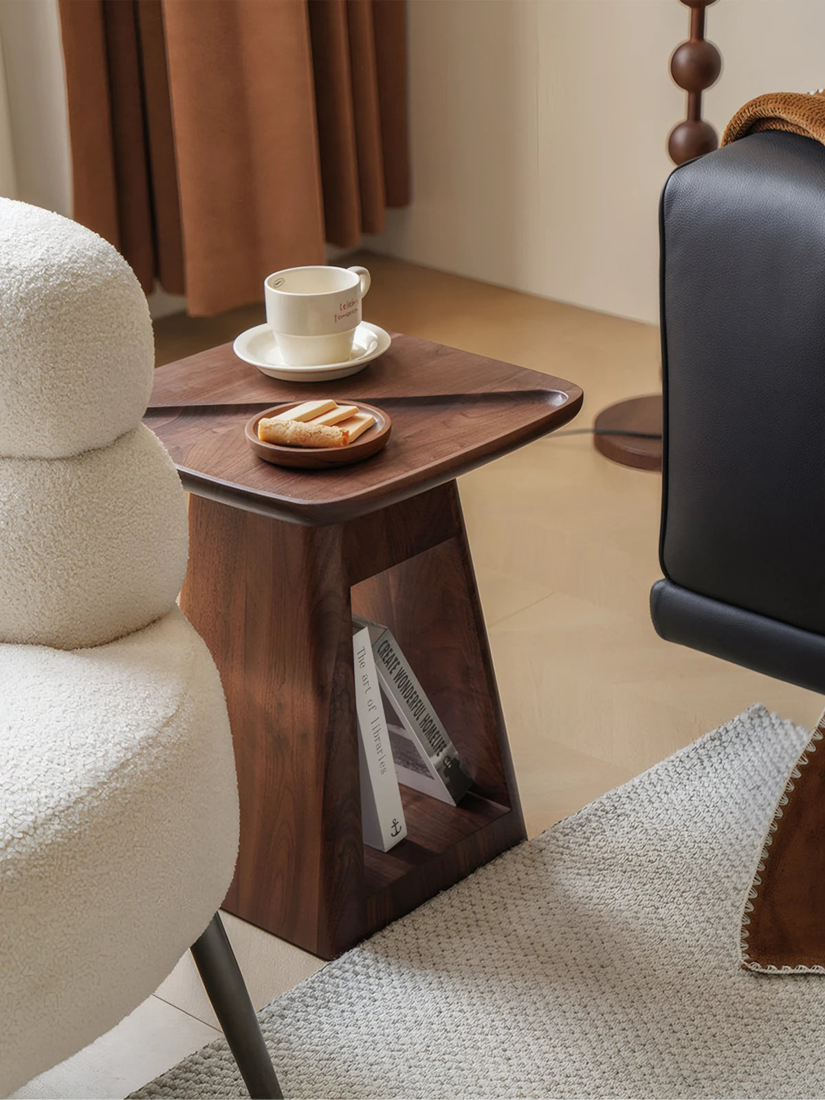 Close-up detail of the North American Black Walnut wood grain and the raised gallery tray top edge on the Kurumi solid wood bedside table.
