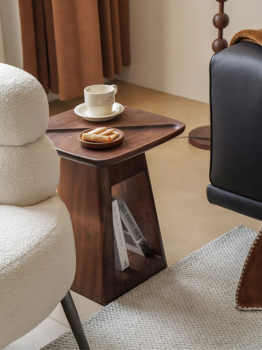 Close-up detail of the North American Black Walnut wood grain and the raised gallery tray top edge on the Kurumi solid wood bedside table.