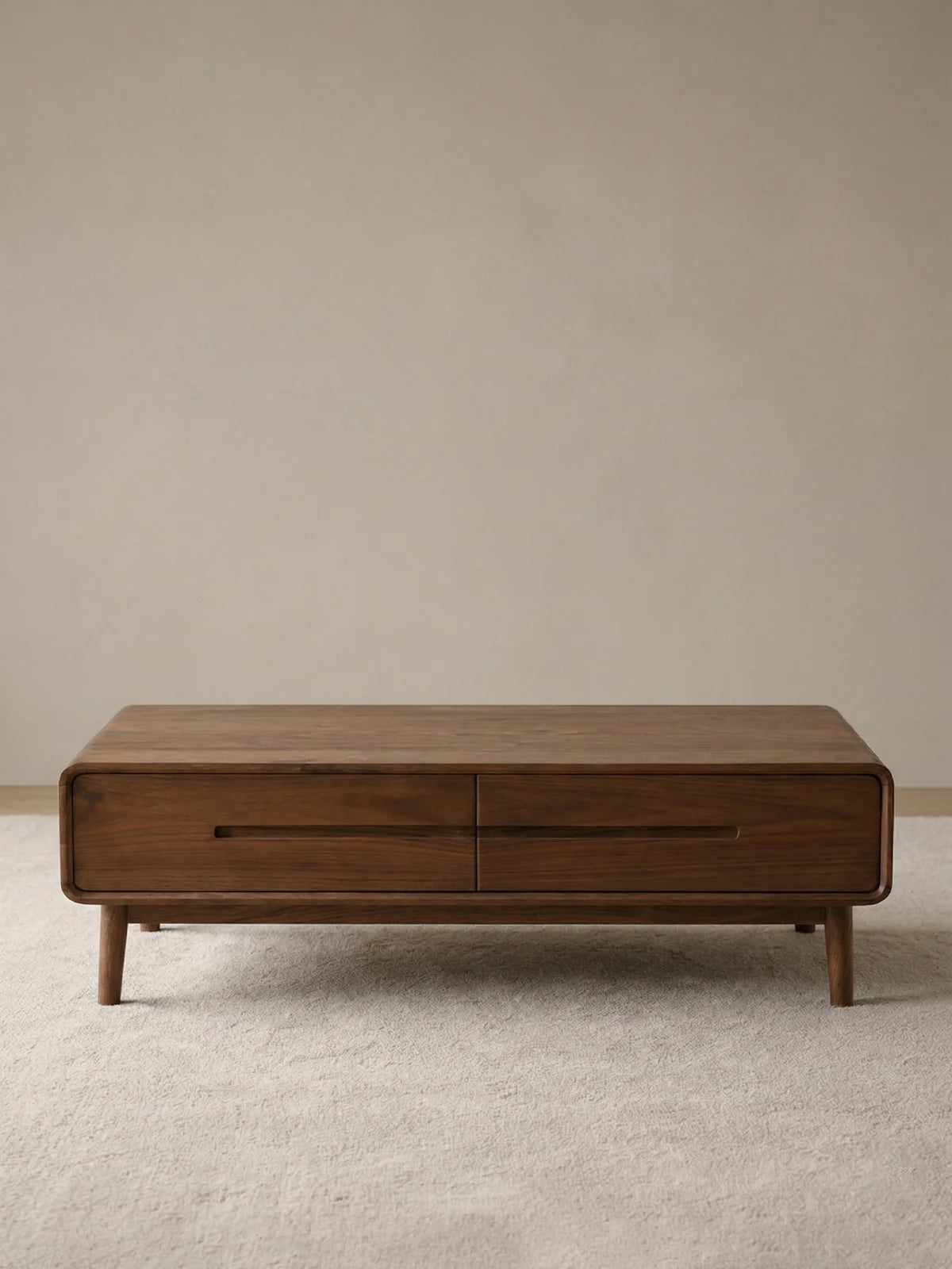 Front view of a solid walnut rectangular coffee table with two drawers and rounded frame edges