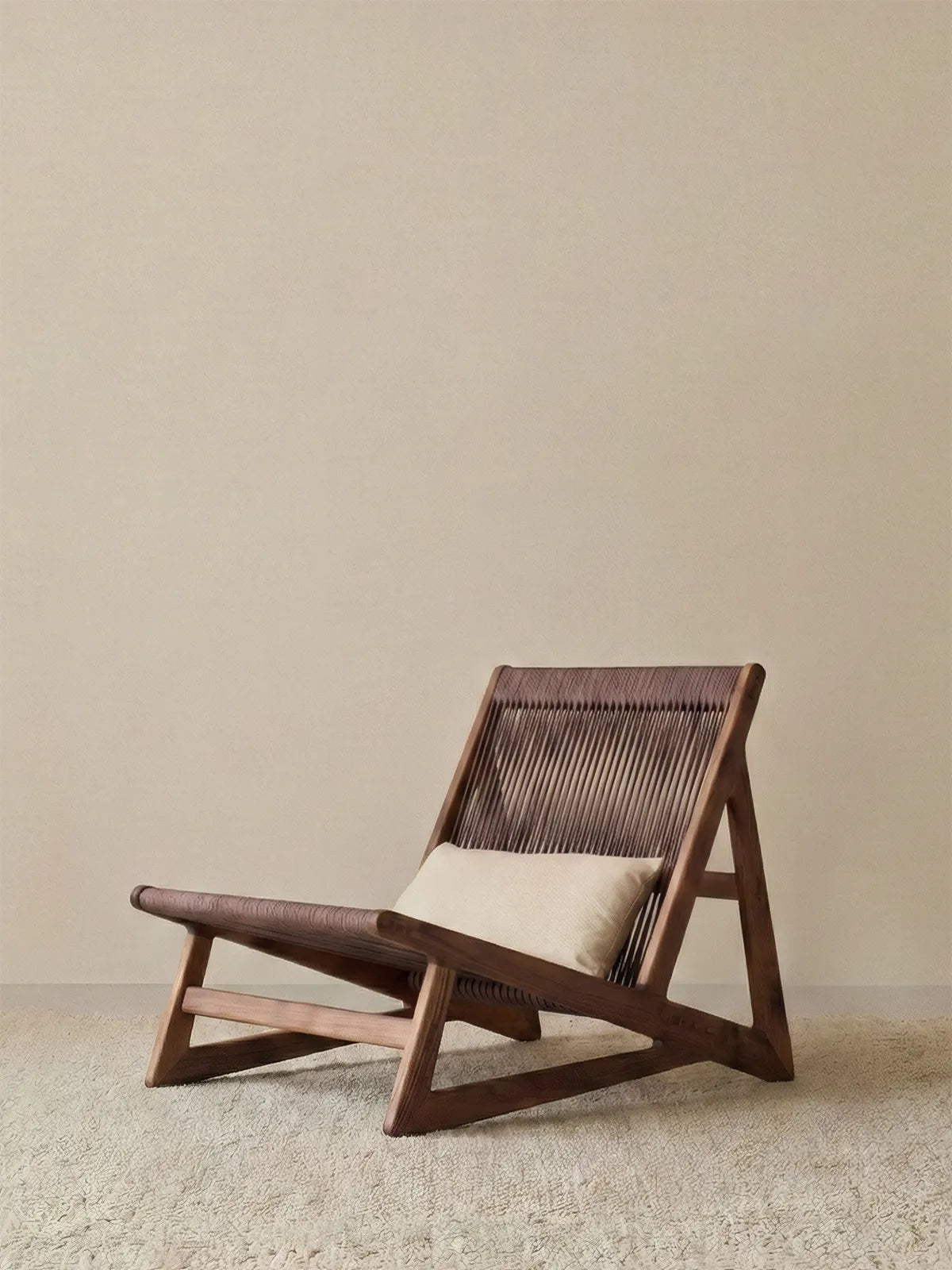 Front view of Walnutry Suiseki lounge chair showing solid black walnut frame and low profile design against a minimal background.
