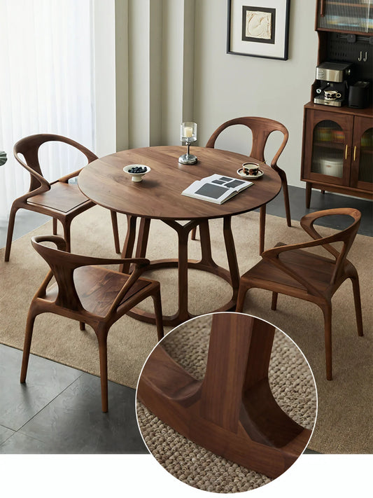 Lifestyle image of the round walnut dining table with an inset close-up of the base connection and circular stretcher.
