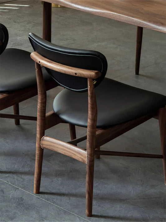 Rear view of the floating backrest and brass accent hardware on these iconic mid century modern chairs.