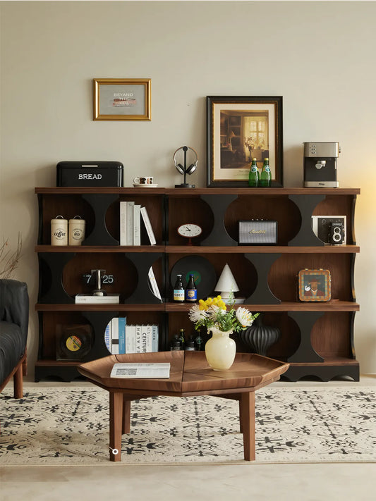 Full view of the Sylvan mid century modern shelving unit styled against a wall with records, plants, and books in a cozy living space.
