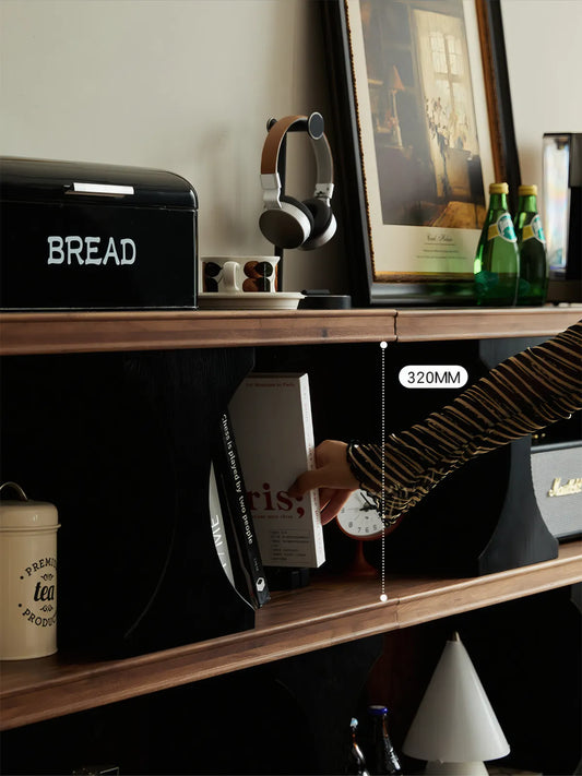 Front view of the Sylvan solid wood bookshelf featuring an asymmetrical geometric design and optimal 320mm shelf heights for display.
