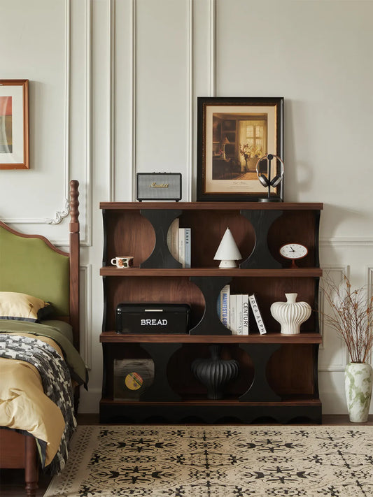 Sylvan solid walnut piece styled beautifully as a solid wood corner bookcase in a bedroom setting, featuring decorative vases and warm wood tones.