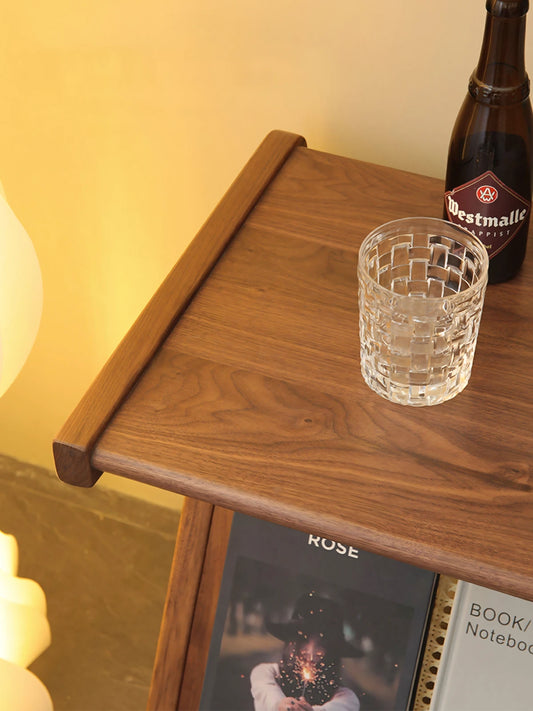 Close-up top view of the solid North American Black Walnut wood grain and smooth edge finish on the Sylvan table.