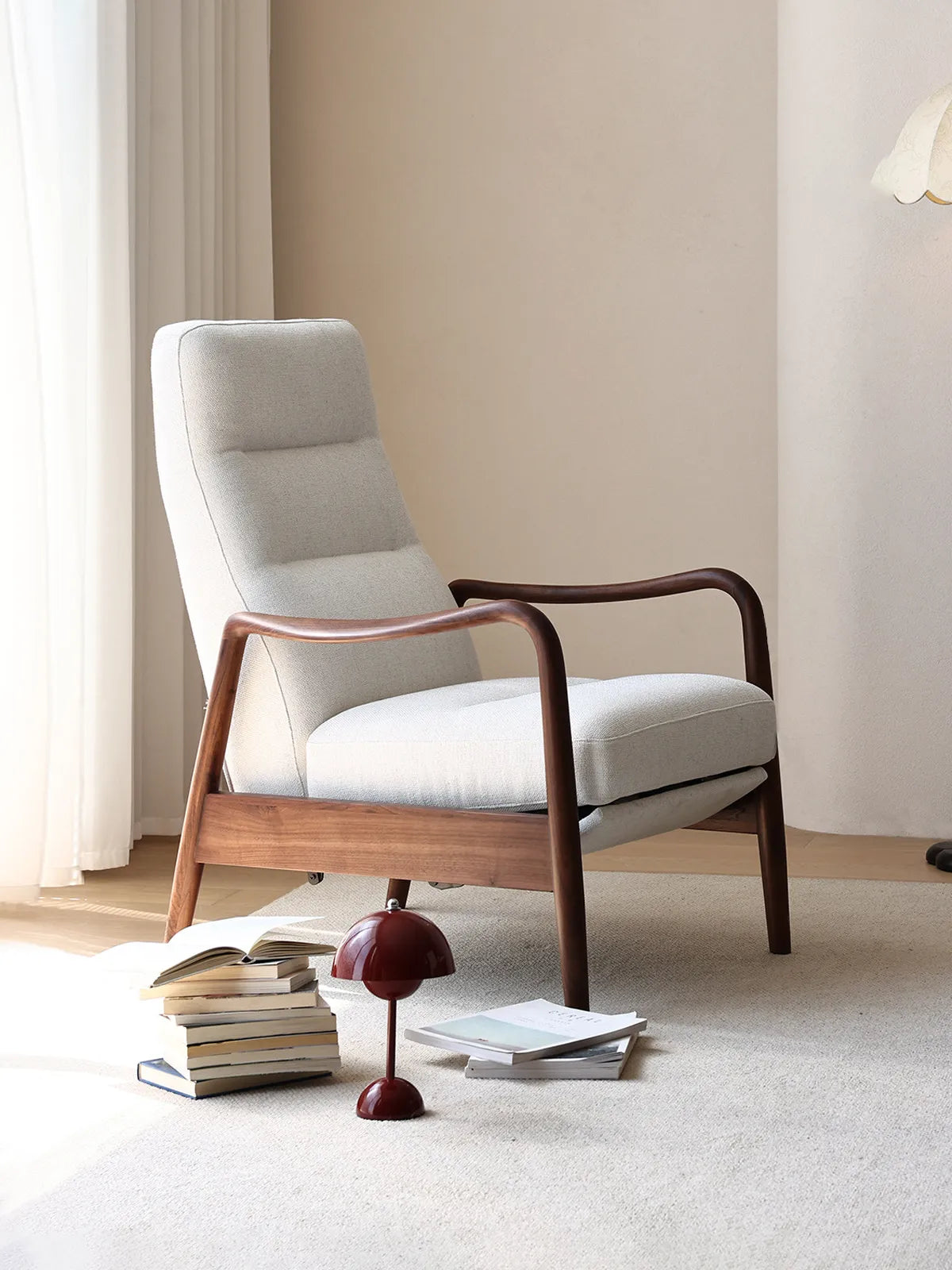 The Haven Lounge Chair in light fabric with solid black walnut arms, styled in a minimalist, sunlit living room.