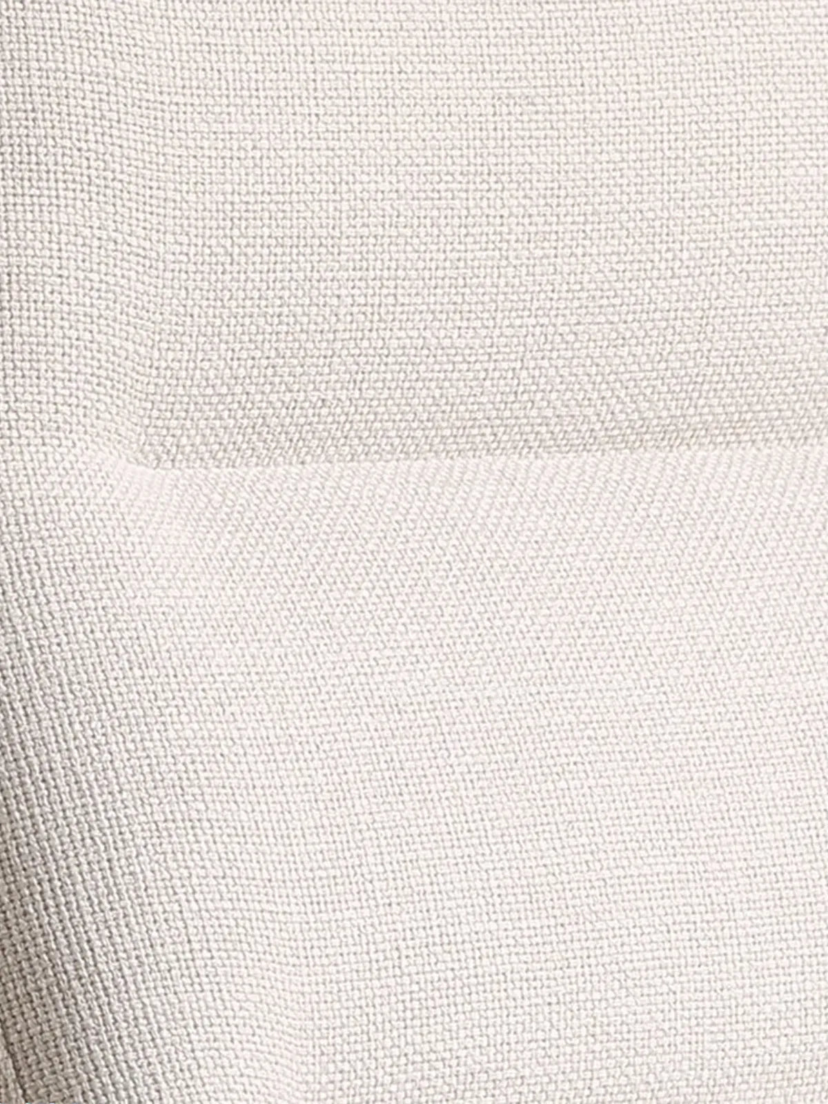 Close-up of the premium, breathable light beige fabric upholstery on The Haven Lounge Chair.