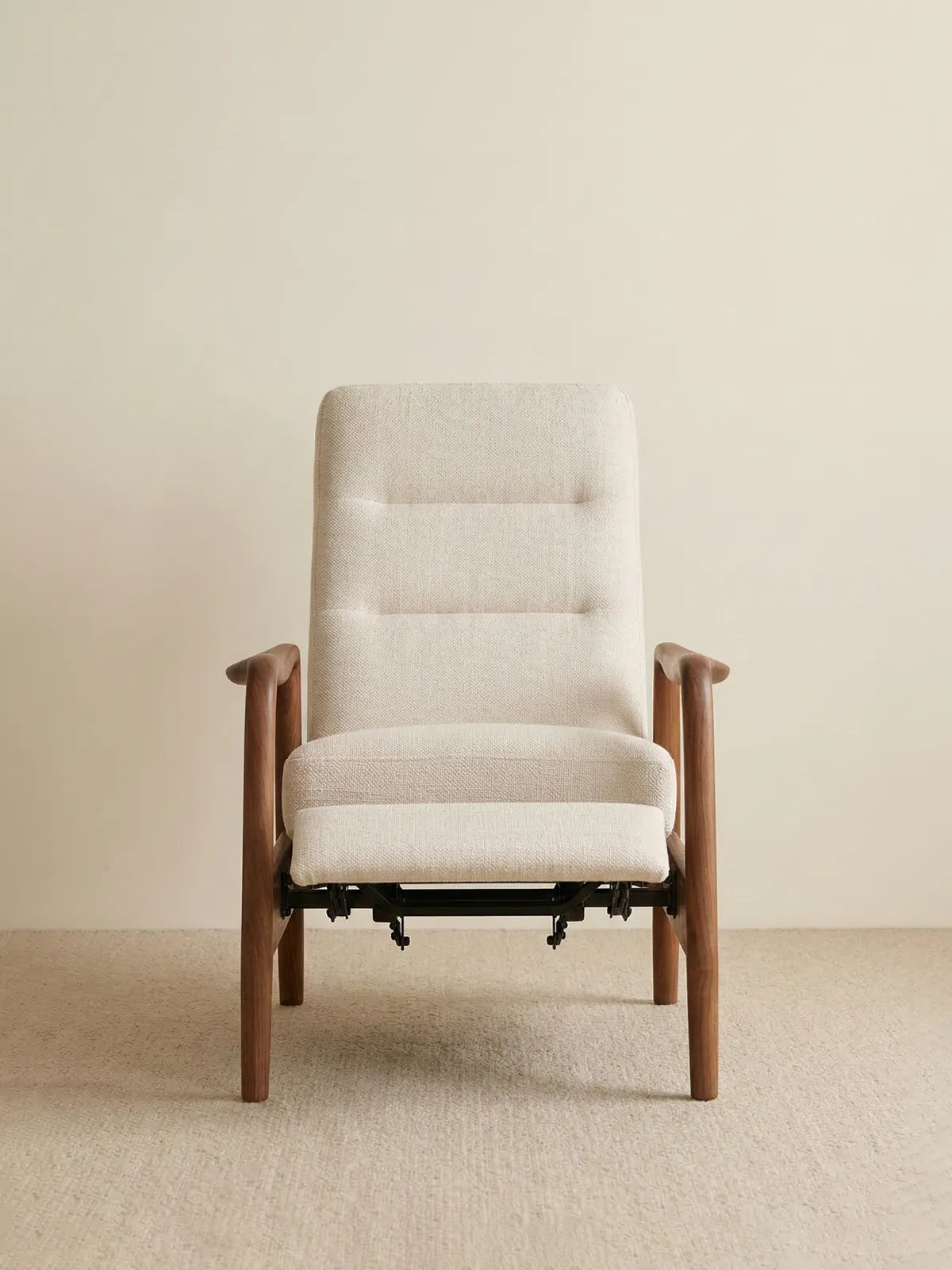 Straight front view of The Haven Lounge Chair in light fabric, showing the pop-out footrest slightly extended.