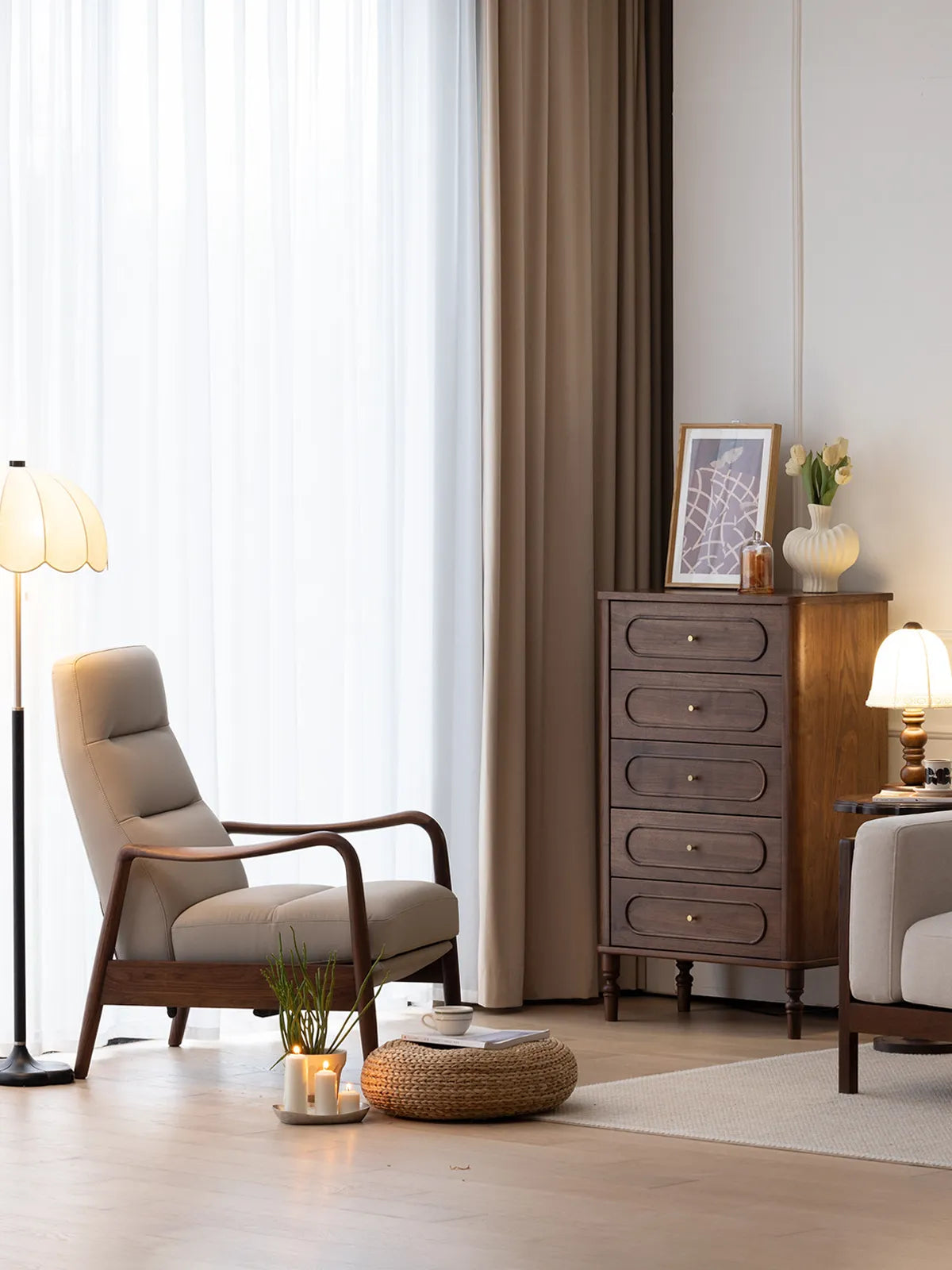 The Haven Lounge Chair in genuine leather with a black walnut frame, placed next to a wooden dresser in an elegant living room.
