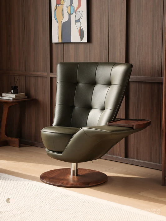 The Helios Retreat Swivel Recliner in green leather with a solid black walnut base and attached side tray, placed in a modern living room.