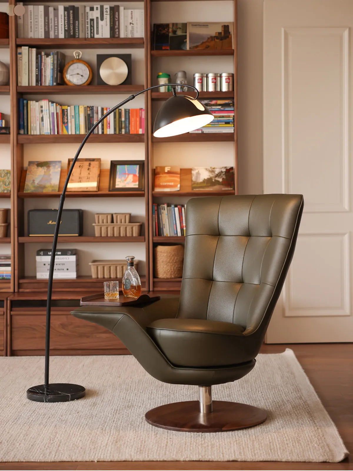 The Helios Retreat Swivel Recliner styled in a cozy home library setting, featuring a solid black walnut base and integrated side table.