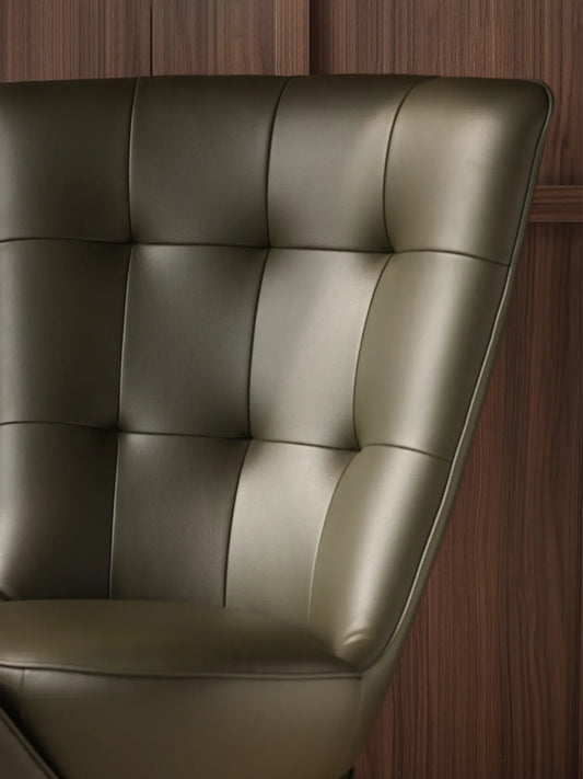 Close-up of the premium tufted green leather backrest on The Helios Retreat Swivel Recliner.