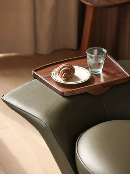 Detailed view of the integrated solid black walnut armrest tray on The Helios Retreat Swivel Recliner.