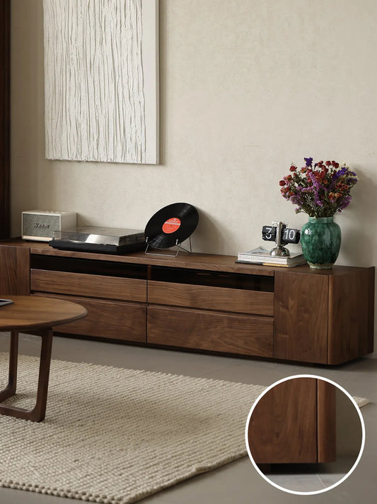 The Pebble Media Console in a living space, featuring a circular inset that highlights its smooth, family-friendly rounded corner design.