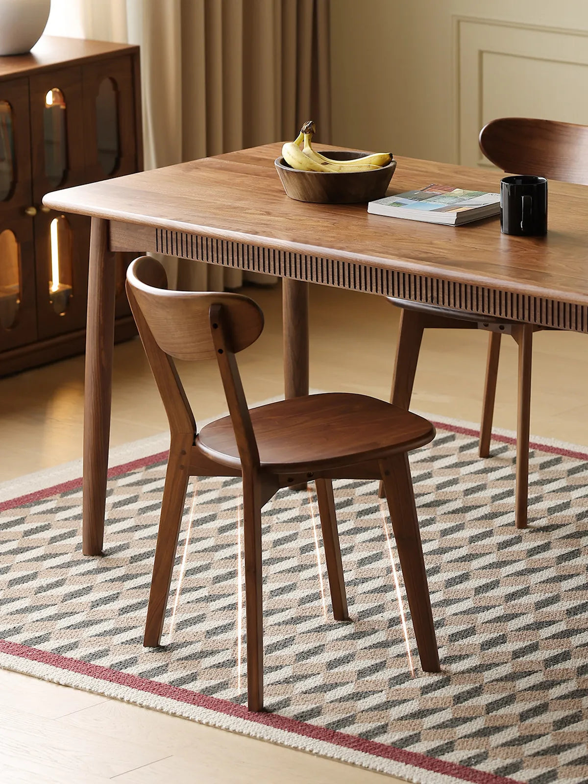Detailed view highlighting the sturdy, tapered solid Black Walnut legs and base construction of The Sylva Dining Chair.