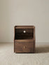 Studio front view of the Walnutry Vantana solid black walnut nightstand with drawers and open shelf.