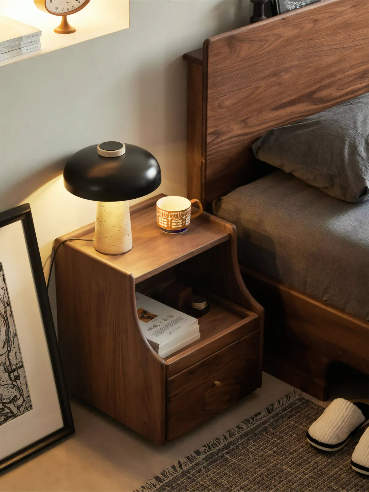 Walnutry Vantana solid North American black walnut nightstand in a modern bedroom setting with warm lighting.