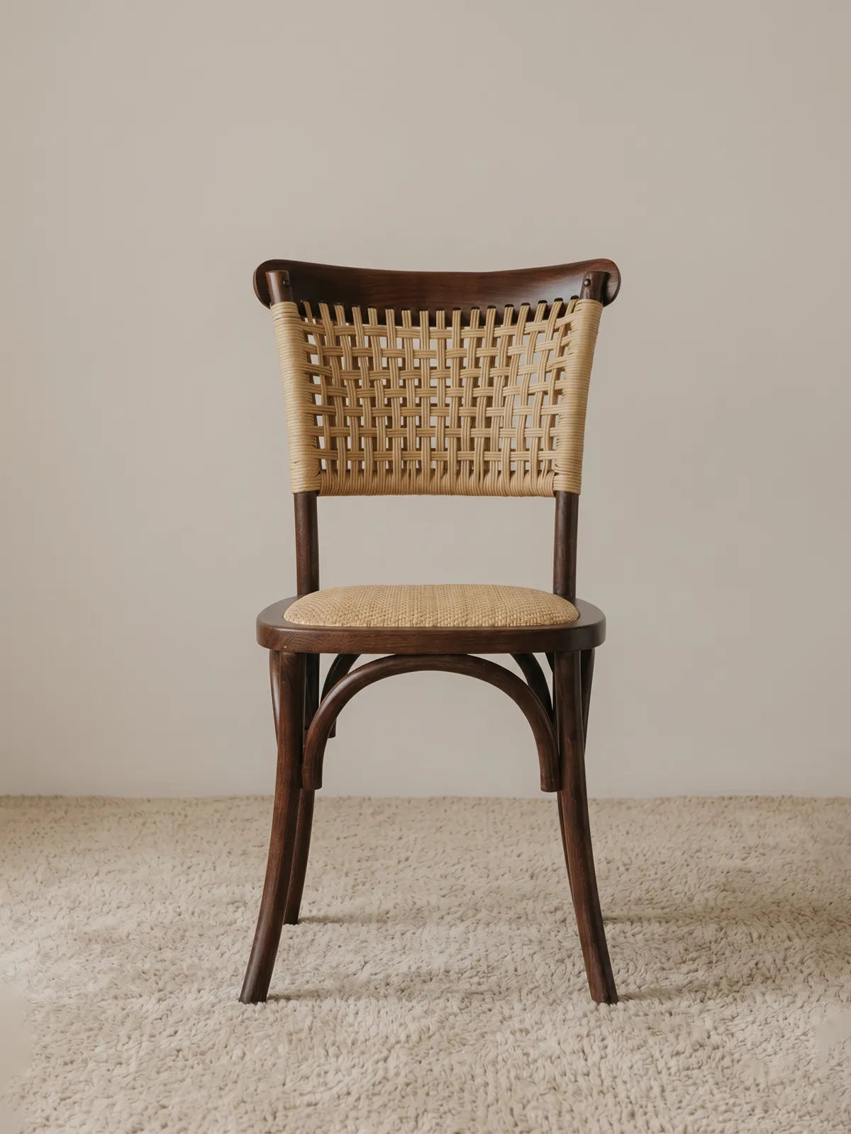 Vilen woven rattan dining chair in solid walnut, front view showing cross-hatch backrest and herringbone seat