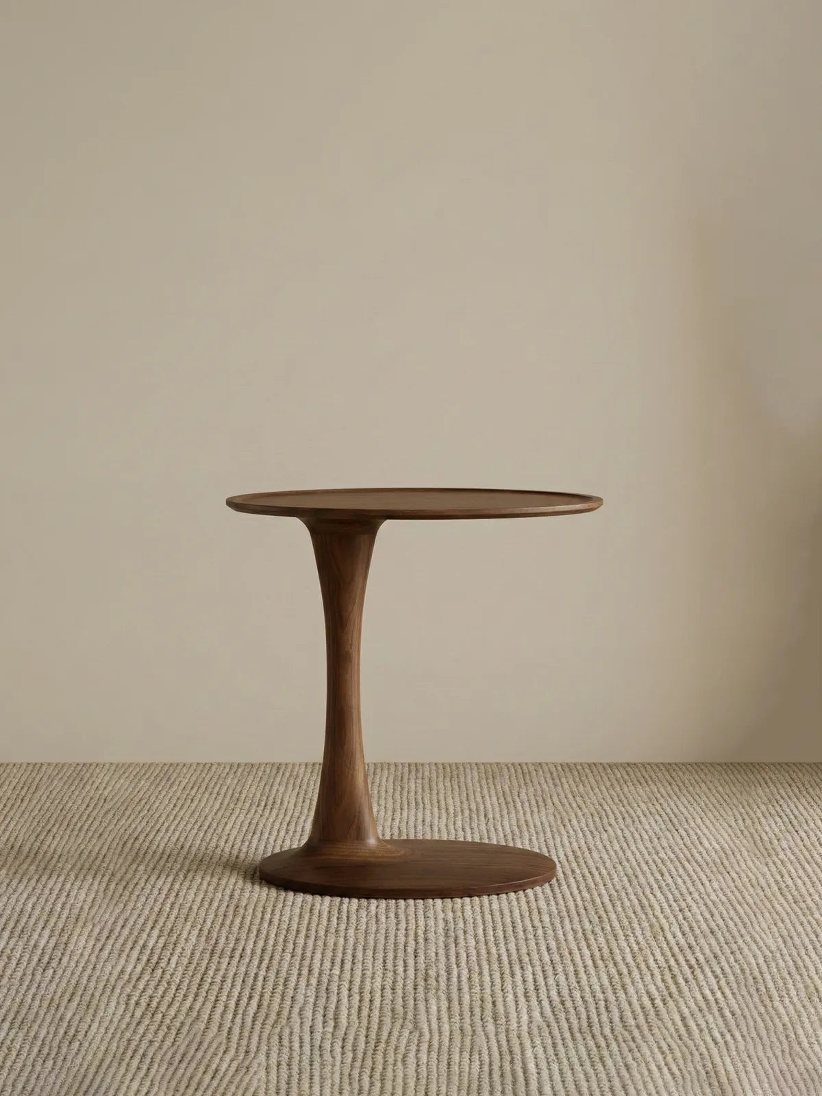 Profile view of The Orbit walnut nightstand modern design isolated against a neutral background, showing its elegant tulip silhouette.