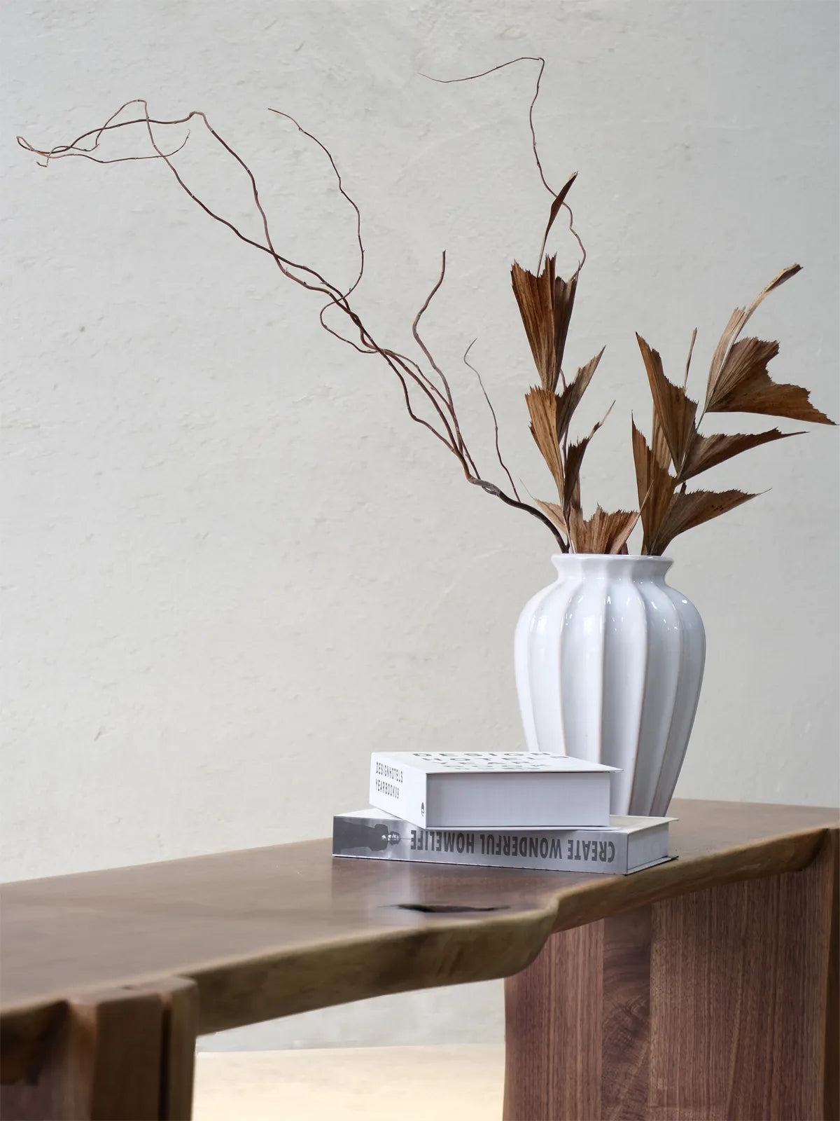 Walnutry Wilder handcrafted walnut bench surface detail with decorative styling, highlighting the natural edge shape and rich wood texture.