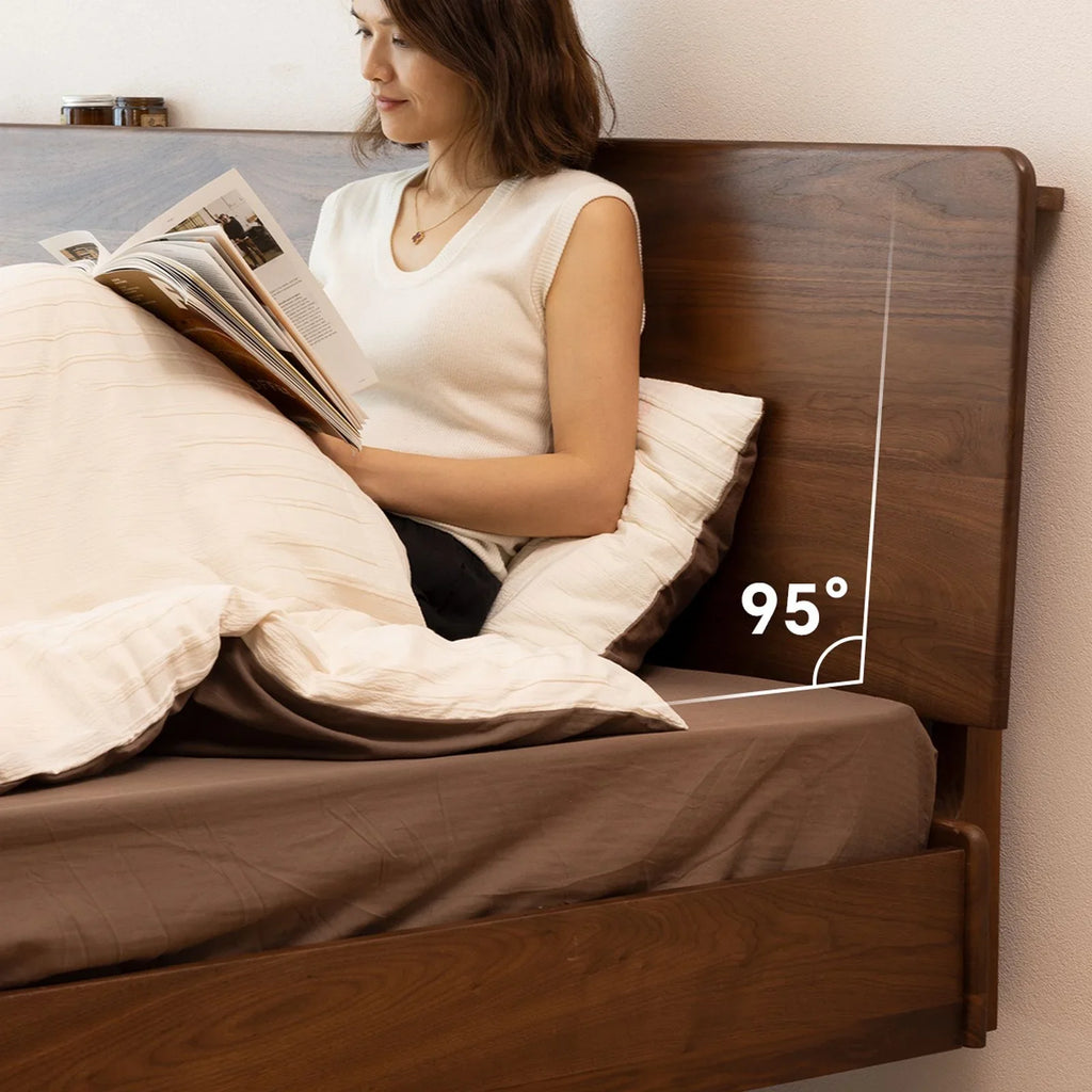 Woman reading in bed with brown wide plank walnut headboard showing 95-degree angle