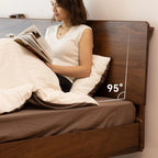 Woman reading in bed with brown wide plank walnut headboard showing 95-degree angle
